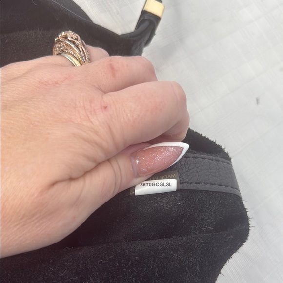 The image shows a Michael Kors Colgate Reversible Grab Bag in black. - Picture 9 of 11